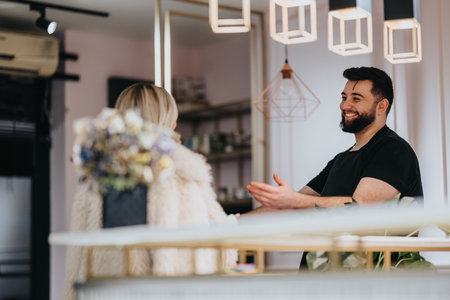 Friendly hair studio consultation between barber stylist and client in a modern salon settingの写真素材