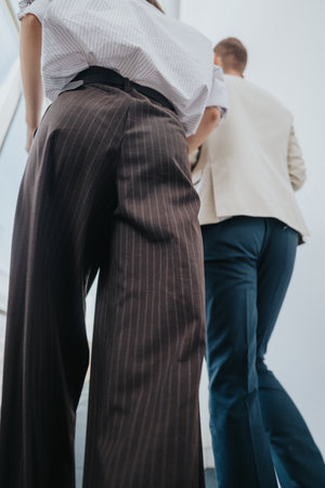 Business colleagues walking up stairs in a modern office, conveying teamwork and momentumの写真素材