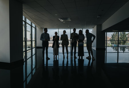 Group of colleagues in a modern office lobby standing together for a business meetingの写真素材