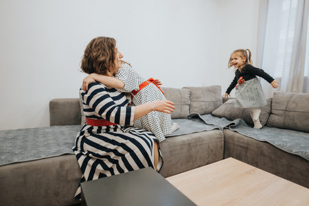 Mother and daughters bonding together in a cozy home settingの写真素材
