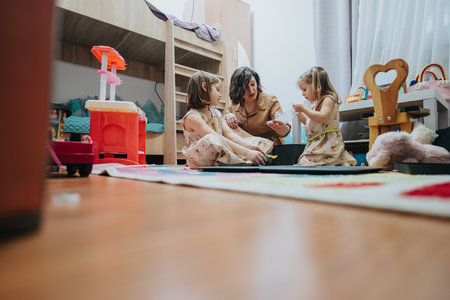 Family engaging in creative play together in a cozy and warm playroomの写真素材