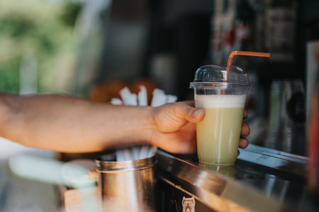 Person handling fresh juice at a mobile food and drink stationの写真素材