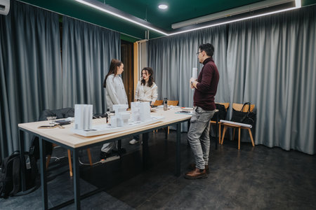Collaboration center meeting with models and discussion among colleagues in a design studio