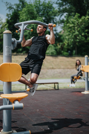 Man exercising on outdoor fitness equipment in a summer park setting