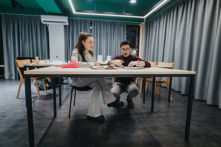 Students collaborate at a modern study center, reviewing documents and notes
