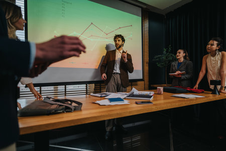 Business presentation in a modern office; colleagues discuss graphs and strategy during meetingの写真素材