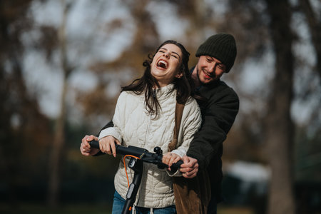 Happy couple enjoying a ride on an electric scooter outdoors, sharing laughter and connection