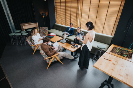Team meeting in a modern lounge as colleagues discuss project ideas and plansの写真素材