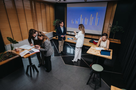 Team of professionals in a modern conference room reviewing charts and collaborating on a project...