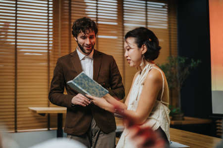 Business colleagues discuss a document indoors during a casual office meeting