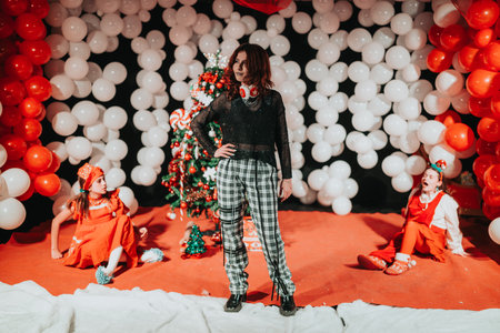 Performer stands center stage in festive Christmas theater scene with children