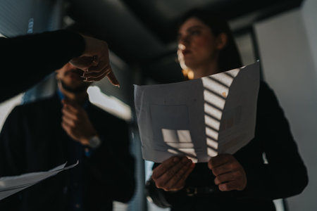 Business team reviews a scribbled document during a focused office meetingの写真素材