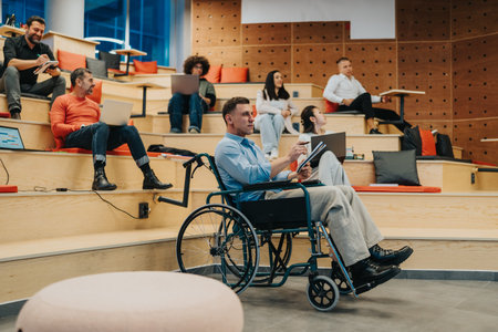 Inclusive classroom scene with diverse students and a man in a wheelchair engaging with devices...