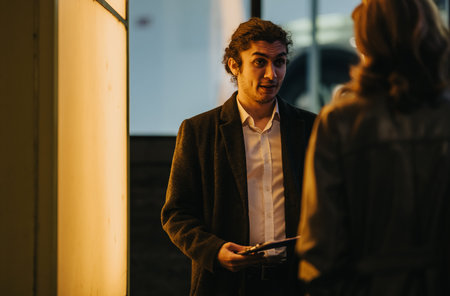 Business associates having a conversation outside at night near an office entrance