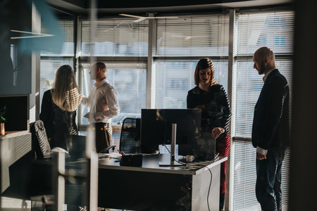 Business team holds a meeting in a bright modern office with sunlight and glass walls