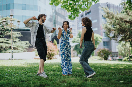 Friends dancing in a city park with modern buildings in the background