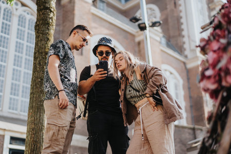 Three friends checking a phone while sightseeing on a Netherlands city street