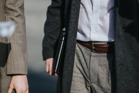 Multicultural colleagues in a business meeting walking outside with tablet and briefcase
