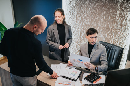 Business team reviewing documents and data during a collaborative office meeting