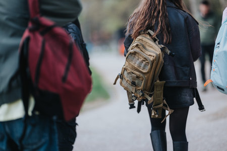 High school students walking with backpacks on a campus path, casual friends heading to class