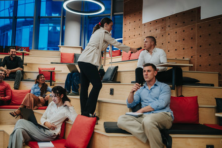 Business meeting with a woman handing a microphone to an audience member during a Q and A session