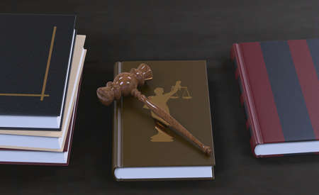 Gavel on a law book with other legal books on the table. Conceptual illustrationの写真素材