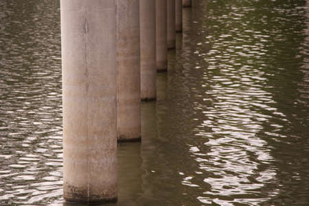cement pillar in waterの写真素材