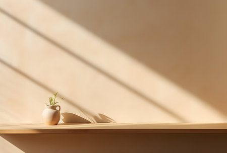 Vase with plant on shelf near beige wall, sunlight effectの素材