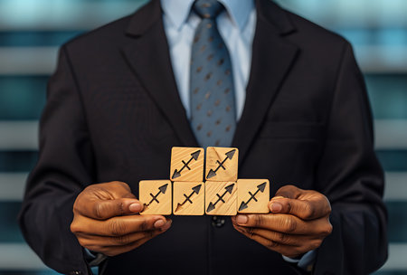 Businessman holding wooden blocks with lightning symbol on top. Business success concept.の素材