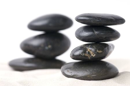 Black pebbles on sandの写真素材