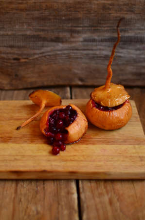 Turnip filled (stewed) with cranberries and honey on the wooden hardboardの写真素材