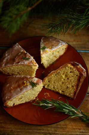 Lemon pie with rosemary and lime icing on the big plate under the fir branches