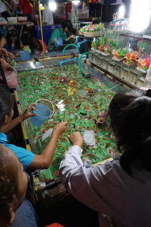 Goldfish scooping game - street market Thailandの写真素材