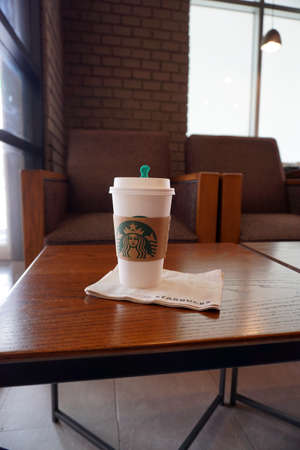 Bangkok, Thailand - January 26, 2016: Starbucks coffee in paper cup with cap. Starbucks is the world's largest coffeehouse companyのeditorial素材