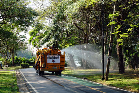 January 28,2016 : Watering the lawn on road by water tanker truck at Somdet-yah park Bangkok, Thailand.のeditorial素材