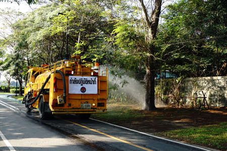 January 28,2016 : Watering the lawn on road by water tanker truck at Somdet-yah park Bangkok, Thailand.のeditorial素材