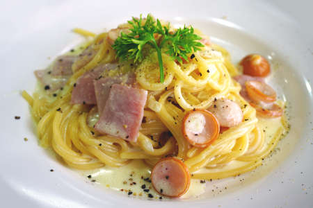 Spaghetti Carbonara with ham and sausageの写真素材