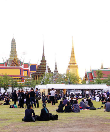 Bangkok,Thailand October 21 ,2016 : Thai people dressed in black as they sit and wait in line to offer condolences for Thailand's late King Bhumibol Adulyadej at the Grand Palace in Bangkokのeditorial素材