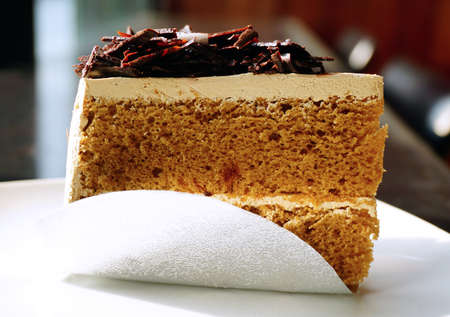 Piece of mocca coffee cake on white plateの写真素材