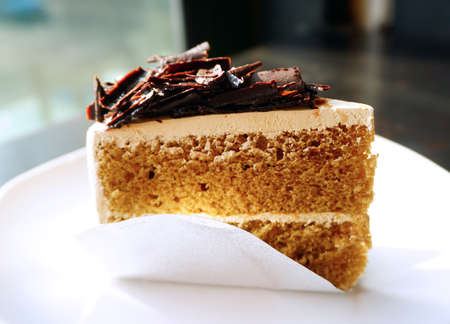 Piece of mocca coffee cake on white plateの写真素材