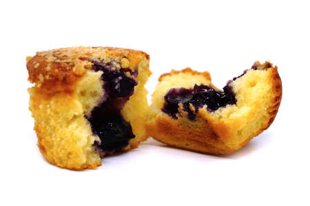 Homemade blackberry muffins covered with sugar powder on white backgroundの写真素材