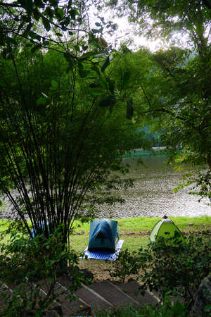The camping tent and backpack in natural parkの写真素材