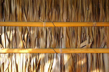 House's wall made from dried leaves of the nipa palm and bamboo. old wall textured background.の写真素材