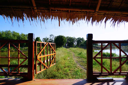 Opening wooden door to outside. Countryside style for summerの写真素材