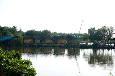 Landscape lake with cottage house village. relaxation waterfront hut in countrysideの写真素材