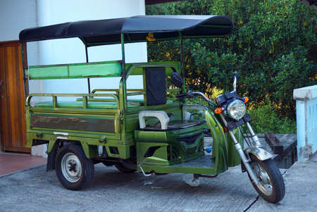 Motor taxi tuk-tuk on the street , motorcyclists , Local vehicle for take passenger in Bangkok Thailandの写真素材