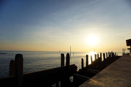 Man made wooden pole of sea wall stand on the Thai bayの写真素材