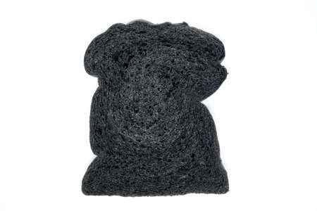 Black charcoal toast bread isolated on white backgroundの写真素材
