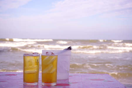 Cold beer with ocean backgroundの写真素材
