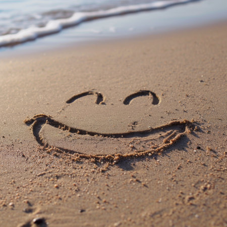 Smiley Face Drawn in the Sand on a Beachの素材